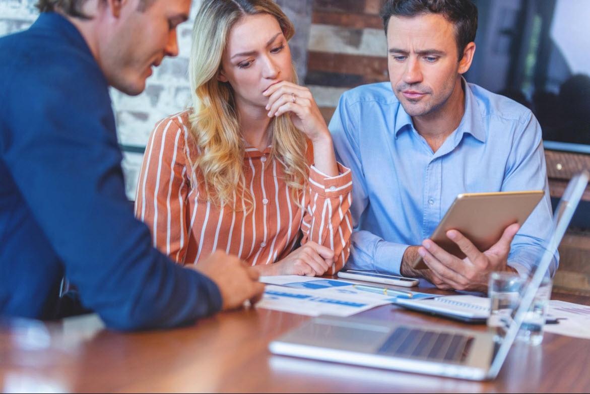 Couple meeting with financial advisor to review investment documents
