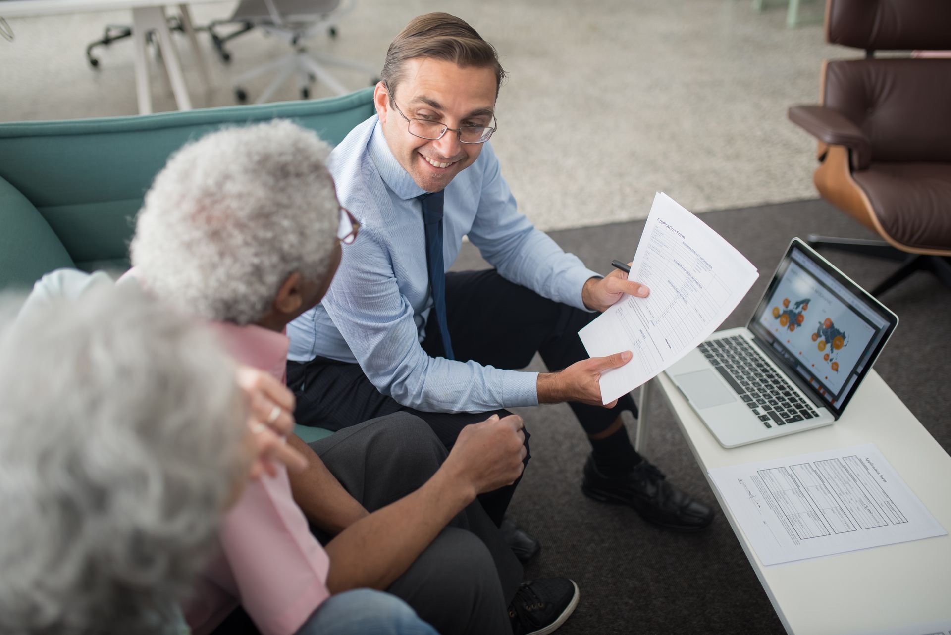 Financial advisor reviewing estate planning documents with an older client