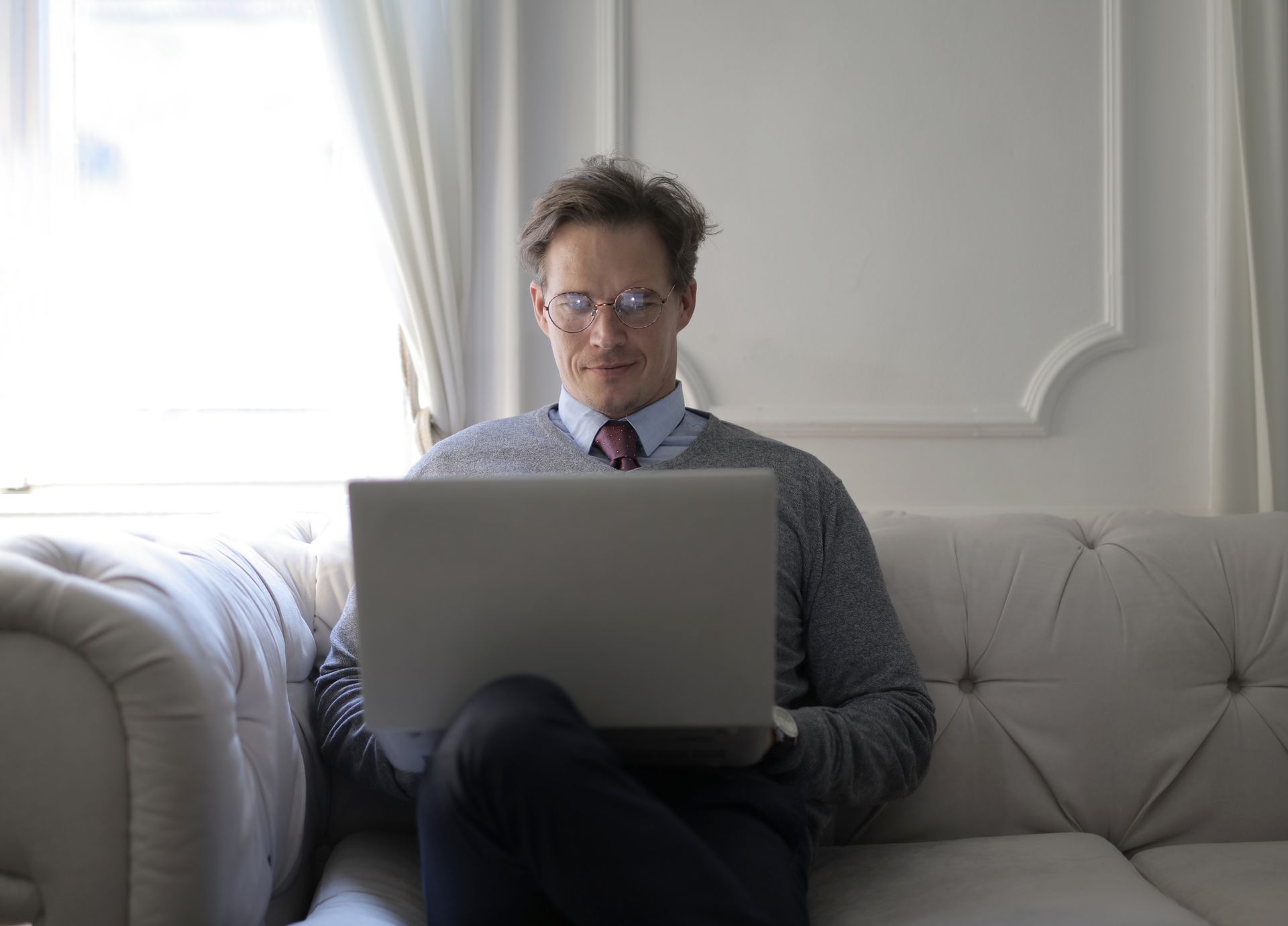 Man sitting on couch with computer
