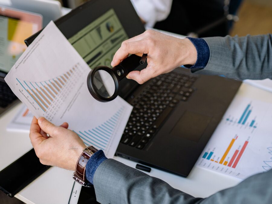 magnifying glass over financial charts